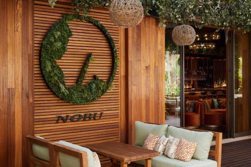 a room with a table and a wreath on a wall at Nobu Hotel Marrakech in Marrakech