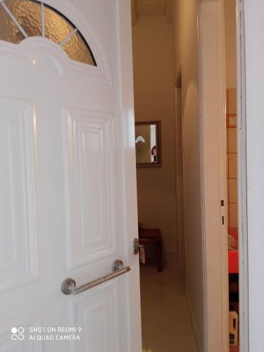 a white door with a handle and a hallway at Angelik Ipsos no5 in Ýpsos