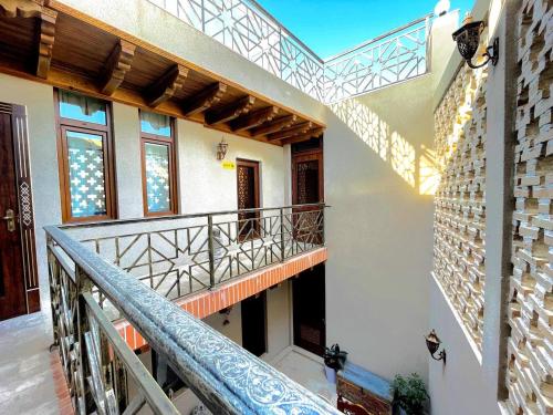 a staircase in a house with a balcony at Bobosh Hotel in Bukhara