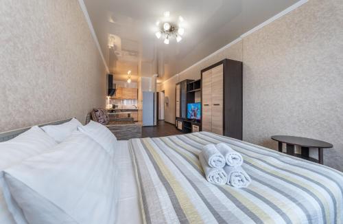 a bedroom with a large bed with towels on it at Теремки in Kyiv