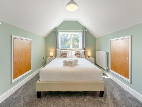 a bedroom with a large white bed with a window at Beach Haven - Uk42241 in Littlestone-on-Sea