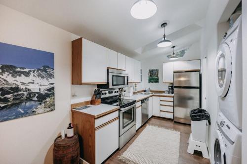 a kitchen with a stove and a refrigerator at 16GS Cabin in Glacier