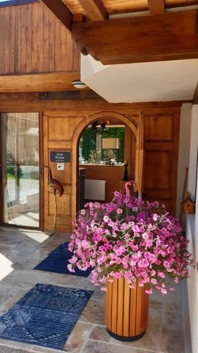 a vase filled with pink flowers in a building at Zwei Hirsche in Seefeld in Tirol