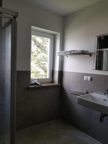 a bathroom with a sink and a window at Hanse Zeit in Bremen