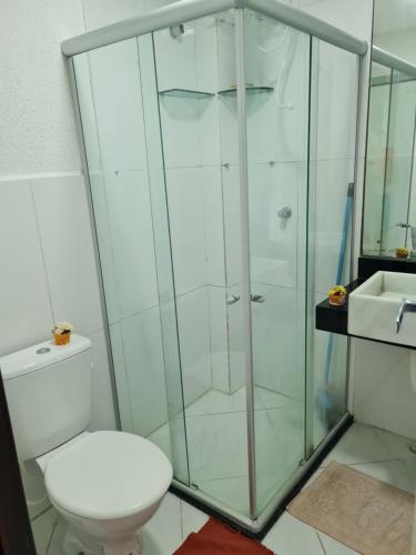 a bathroom with a shower with a toilet and a sink at Condomínio mar e sol in Conde