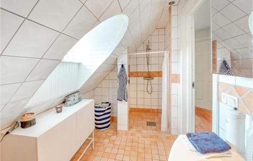 a bathroom with a surfboard on the wall at Awesome Home In Genarp With Wifi in Genarp