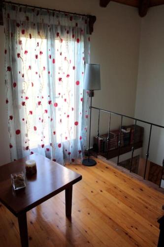 a living room with a table and a window at Fragosiko - Rustic Retreat in Kefalonia in Argostoli