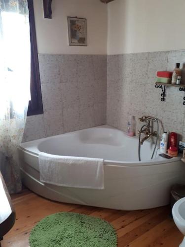 a bath tub with a faucet in a bathroom at Fragosiko - Rustic Retreat in Kefalonia in Argostoli