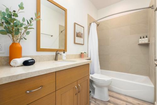 a bathroom with a sink and a toilet and a mirror at #ML - Aloha Hoʻonani 3BR Home - MT & Ocean Views! in Waianae