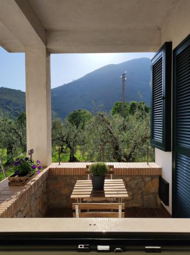 a patio with a table and a view of a mountain at La Cèsa in Itri
