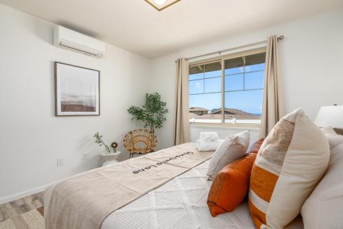 a bedroom with a bed and a window at @ Marbella Lane - 3BR w/ Phenomenal Ocean+MT views in Waianae
