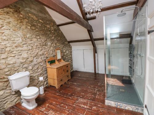 a bathroom with a toilet and a glass shower at 2 Ashgrove in Dinas