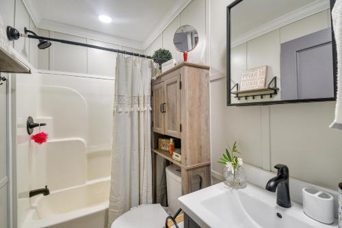 a bathroom with a sink and a toilet and a mirror at Adorable Studio about 1 Mi to Cherry Grove Beach! in Myrtle Beach