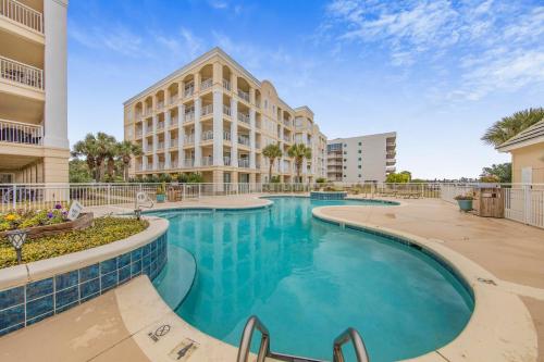 a swimming pool in front of a building at Perdido Grande 2502 by Vacation Homes Collection in Orange Beach