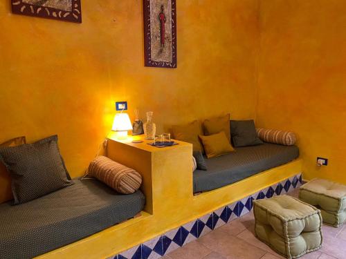 a living room with two couches and a table at Il Profumo del Sale in Marsala