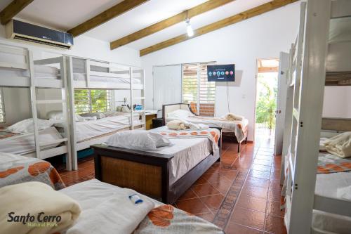 a room with a bunch of bunk beds at Hotel Santo Cerro Natural Park in Santo Cerro