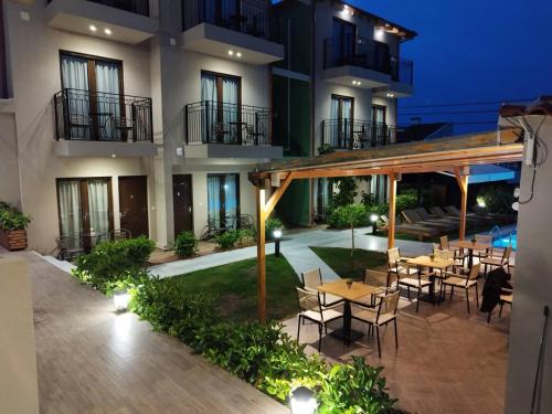 a patio with tables and chairs in front of a building at Oro in Skiathos Town