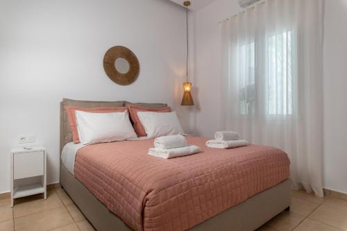 a bedroom with a bed with two towels on it at Ierapetra’s Mosque House in Ierápetra