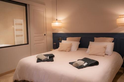 a bedroom with a bed with two towels on it at Suite de Luxe Jacuzzi balnéo,King size Bed in Collobrières