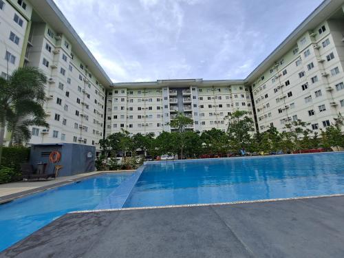 a large apartment building with a large swimming pool at Amaia Steps Altaraza by GEMcondotel in Tunkong Manga