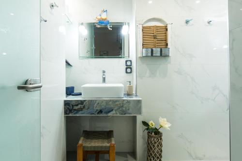 a bathroom with a sink and a mirror at Arodamos Studios & Apts in Kissamos