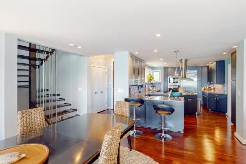 a dining room and kitchen with a table and chairs at Taids Inn in Odenton