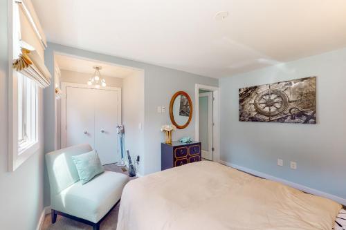 a bedroom with a bed and a chair and a mirror at Taids Inn in Odenton