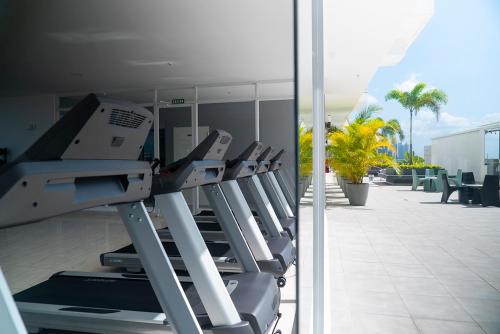 a row of treadmills on the side of a building at private ocean view studio apartment in Panama City