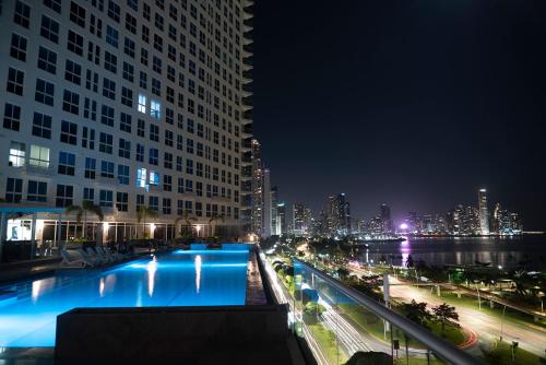 a view of a city at night with a building at private ocean view studio apartment in Panama City