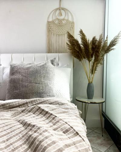 a bedroom with a bed and a vase on a table at Himalayas in Gjirokastër