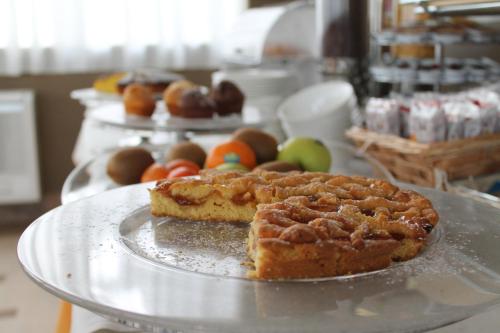 a pie on a plate on a table with other foods at Il Parco Sul Mare Resort & SPA in Tortoreto Lido