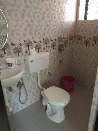 a bathroom with a toilet and a sink at Paradise guest view in Nandaprayāg