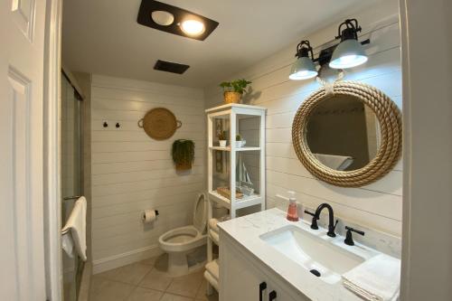 a bathroom with a sink and a toilet and a mirror at Bluff Villas 1807 in Hilton Head Island