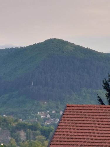 une montagne au loin avec un toit rouge dans l'établissement Robyland, à Visoko
