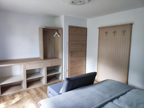 a bedroom with a blue bed and a closet at Apartmaji Mojca in Bohinj