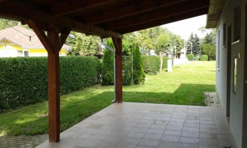 an outdoor patio with a pavilion in a yard at Silver Apartman Patince in Patince