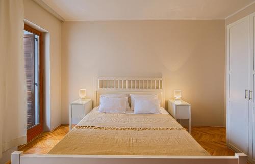 a bedroom with a large bed with two night stands at Apartment Family in Petrovac na Moru