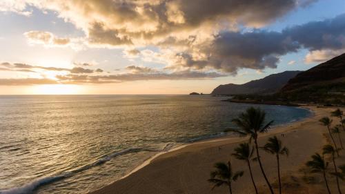 a view of a beach with palm trees and the ocean at #ML - Aloha Hoʻonani 3BR Home - MT & Ocean Views! in Waianae
