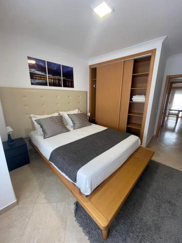 a bedroom with a large bed with a wooden headboard at Cricket Apartments in Ferrel