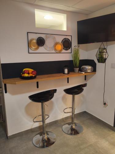 a bar with two stools in a room at Nika 2 in Rijeka