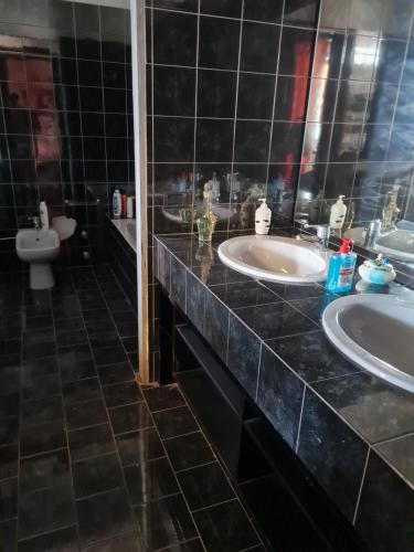 a bathroom with two sinks and a toilet at VILLA GIOVANNA in Bergamo