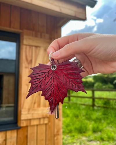 a person holding a red leaf in front of a building at The Weeping Willow in Bury Saint Edmunds