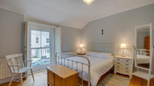 a bedroom with a bed and a window at Woodville Road, Mumbles in The Mumbles