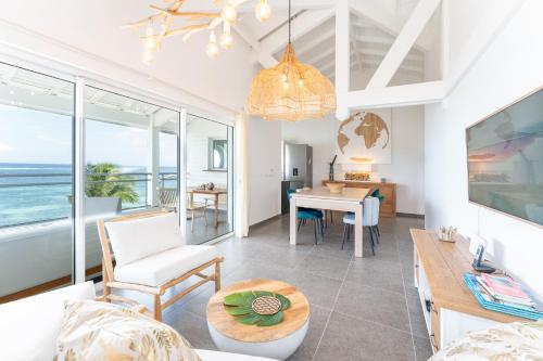 a living room with a view of the ocean at Only4view - Rooftop & spa Sainte-Anne in Sainte-Anne