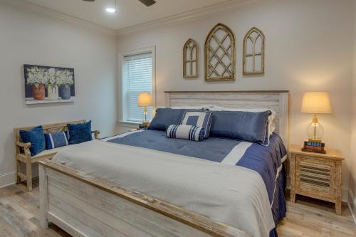 a bedroom with a large bed with blue pillows at WFH-Friendly Condo Rental in Nashville, Georgia! 