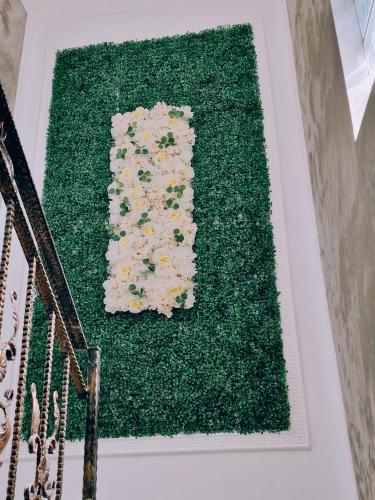 a green rug with flowers on top of a staircase at Vila N&N Palace in Bistriţa Bîrgăului