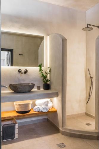 a bathroom with a sink and a mirror at 23 Smart Suite by The Villa Collector in Imerovigli
