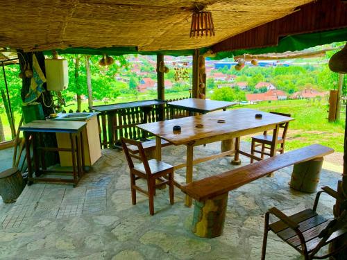 a wooden table and chairs on a patio at Etno selo Stanojevic in Boljevac