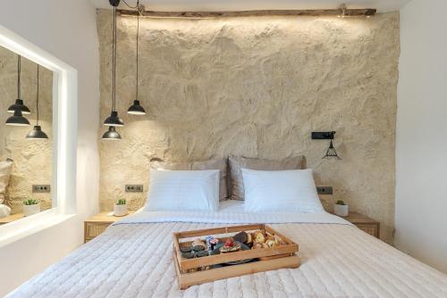 a bedroom with a bed with a tray of toys on it at 23 Smart Suite by The Villa Collector in Imerovigli