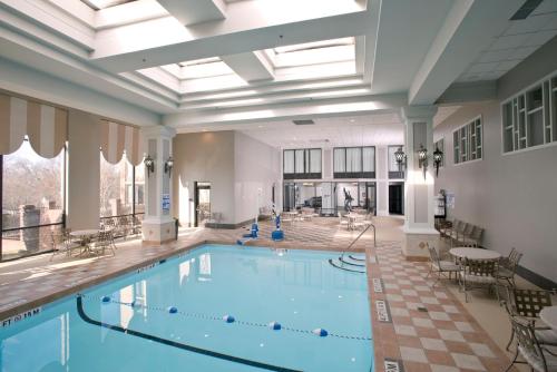 a pool in a large room with a large ceiling at Crowne Plaza Greenville by IHG in Greenville